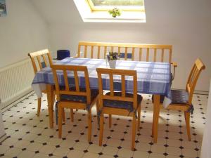 a dining room table with a blue and white table and chairs at Ferienwohnung in Dornumersiel 20-070 in Dornumersiel