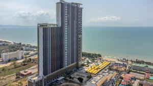 an aerial view of a tall building next to the ocean at Copacabana beach jomtien in Jomtien Beach