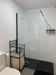 a bathroom with a glass shower and a toilet at Cal Morenet in Palamós +9 photos
