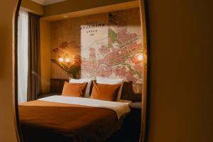 a hotel room with a large bed with orange pillows at Amante Narikala Boutique Hotel in Tbilisi City