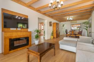 a living room with a fireplace and a tv at Sa Capella in Santa Margalida