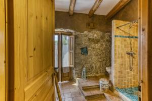 a bathroom with a shower and a toilet at Casa de Pueblo in Cantallops
