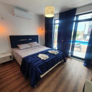 a bedroom with a bed with two towels on it at Capitan Niko Apartments in Burgas City