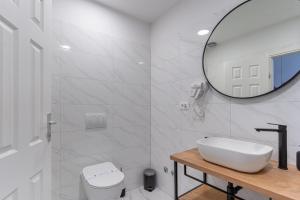 a white bathroom with a sink and a mirror at Room in Cres with sea view, balcony, air conditioning, WiFi 4249-4 in Cres