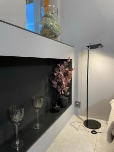 a room with two wine glasses on a shelf at Aggi - Apartament Premium z widokiem na morze - AZW Gdańsk in Gdańsk