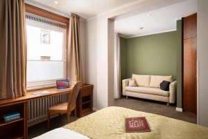 Postel nebo postele na pokoji v ubytování Hotel Baseler Hof