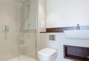 a bathroom with a shower and a toilet and a sink at The Unity in London