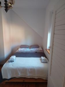 a small bedroom with a bed in a room at Ostoja u Moni in Stare Juchy