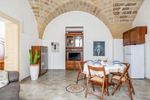 a kitchen with a table and chairs in a room at Terra Mia In The Historic Center Of Lecce - Happy Rentals in Lecce +13 photos