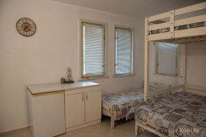 a bedroom with a bed and a bunk bed at Вили Водно Конче Villas Vodno Konche in Ahtopol