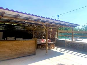 a wooden pergola on a patio with a table at CASA RURAL MOLINO DEL JERTE in Navaconcejo