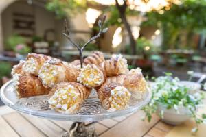 a glass plate of pastries on a table at Antica Dimora Del Gruccione, Albergo diffuso in Santu Lussurgiu