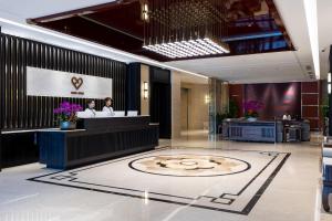 a lobby of a hotel with a reception desk at Dijon Hotel Shanghai in Shanghai