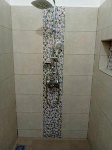 um chuveiro com uma parede de pedra na casa de banho em Sweet home 