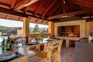 a kitchen with a table and a fireplace at Apartments Lucija in Slunj