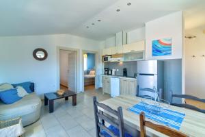 a kitchen and living room with a table and a couch at MT SUN 115 App 1 in Selce