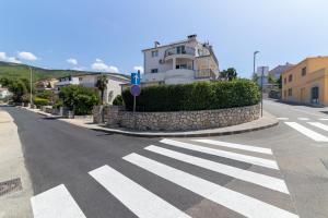 a street with a crosswalk in front of a building at MT SUN 115 App 1 in Selce +4 photos