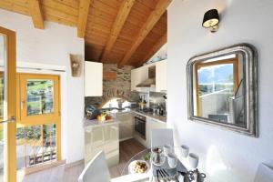 a kitchen with a table and a mirror on the wall at Belmonte Terrazzo in Pianello Del Lario