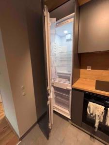 an empty refrigerator with its door open in a kitchen at 7Mins City Garden and Center+P in Plovdiv