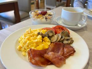 a plate of breakfast food with scrambled eggs and mushrooms at Perla Marina in Nerja