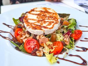 a plate of food with a salad on a white plate at Perla Marina in Nerja
