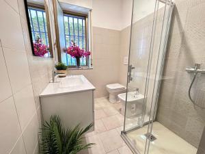 a bathroom with a shower and a sink and a toilet at Villa Eleonora in Palmi