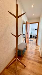 a living room with a chair and a wall at LILLE`S apartment in city center in Alūksne