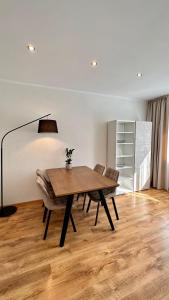 a dining room with a wooden table and chairs at LILLE`S apartment in city center in Alūksne