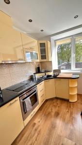 a kitchen with wooden floors and a stove top oven at LILLE`S apartment in city center in Alūksne