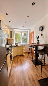 a kitchen with a table and a dining room at LILLE`S apartment in city center in Alūksne