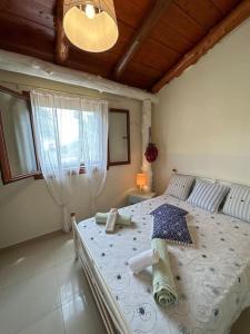 a bedroom with a large bed with an umbrella on it at Souda’s nest in Plakias