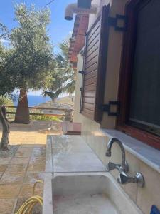 a kitchen sink with a view of the ocean at Souda’s nest in Plakias