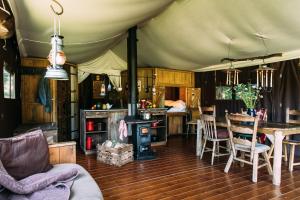 a living room with a tent with a table and a stove at College Farm by Feather Down in Beccles