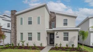 a white house with a palm tree in front of it at 1249 Challenge in Davenport