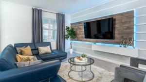 a living room with a blue couch and a tv at 1249 Challenge in Davenport