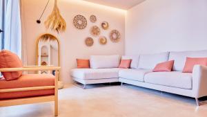 a living room with two couches and plates on the wall at Azar Luxury Suites in Vlorë