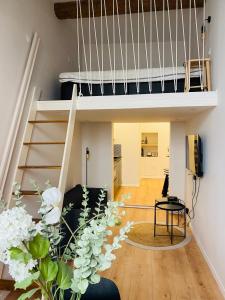 a loft apartment with a staircase and a living room at Vieux Nice Charmante Mezzanine in Nice