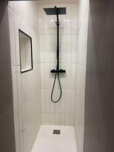a bathroom with a shower with a black shower head at Vieux Nice Charmante Mezzanine in Nice