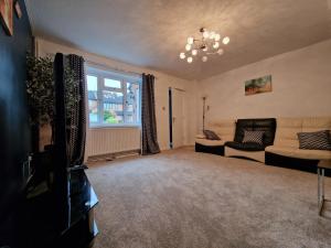 a living room with a couch and a window at Nice Living Serviced Accommodations 7 in Rugby