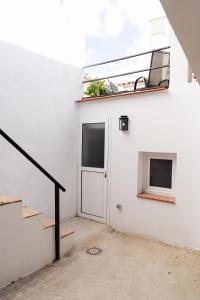 ein weißes Gebäude mit einer Tür und einem Fenster in der Unterkunft Casa Luna de Antequera in Antequera