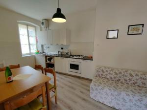 a living room with a table and a kitchen at Casa Maria Angela in Ledro +12 photos
