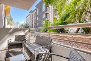 a balcony with chairs and a train tracks at Studio City 2br w pool gym wd nr Olive Ave LAX-922 in Los Angeles