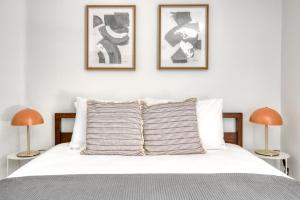a bedroom with a bed with two pictures on the wall at Studio City 2br w pool gym wd nr Olive Ave LAX-922 in Los Angeles +31 photos