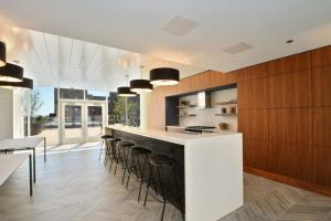 a kitchen with a bar with stools at South Loop 1BR w gym pool nr Grant Park CHI-764 in Chicago