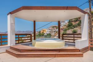 a gazebo on a balcony with a view of the ocean at Vasilis Studios Family House in Kalymnos