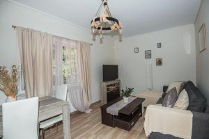 a living room with a couch and a table at Sea Zen Guesthouse in Rafina