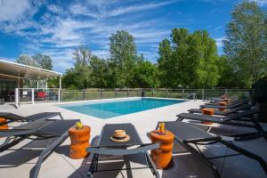 a pool with chaise lounge chairs and a swimming pool at ibis Golfe de Saint-Tropez in Cogolin