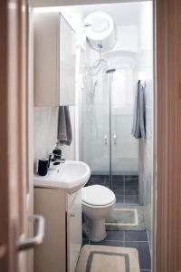 a bathroom with a toilet and a sink and a shower at Apartman Green in Zagreb +10 photos