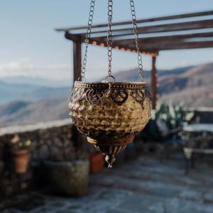 a hanging planter is hanging from a chain at Ca'Luni in Casola in Lunigiana