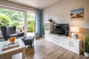 TV a/nebo společenská místnost v ubytování Haus Nordseeblick Wohnung 3